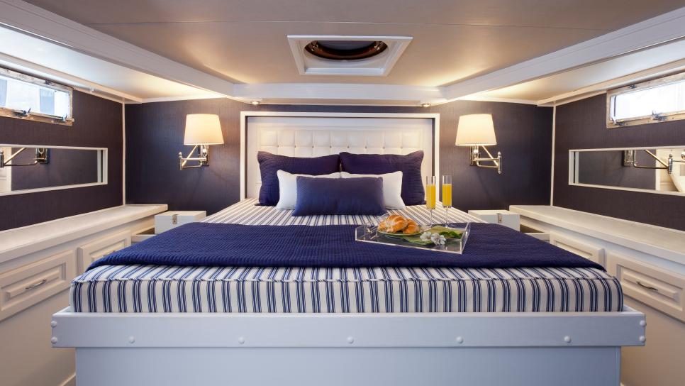 Blue Coastal Bedroom With Striped Bed Linens Blue Coastal Bedroom