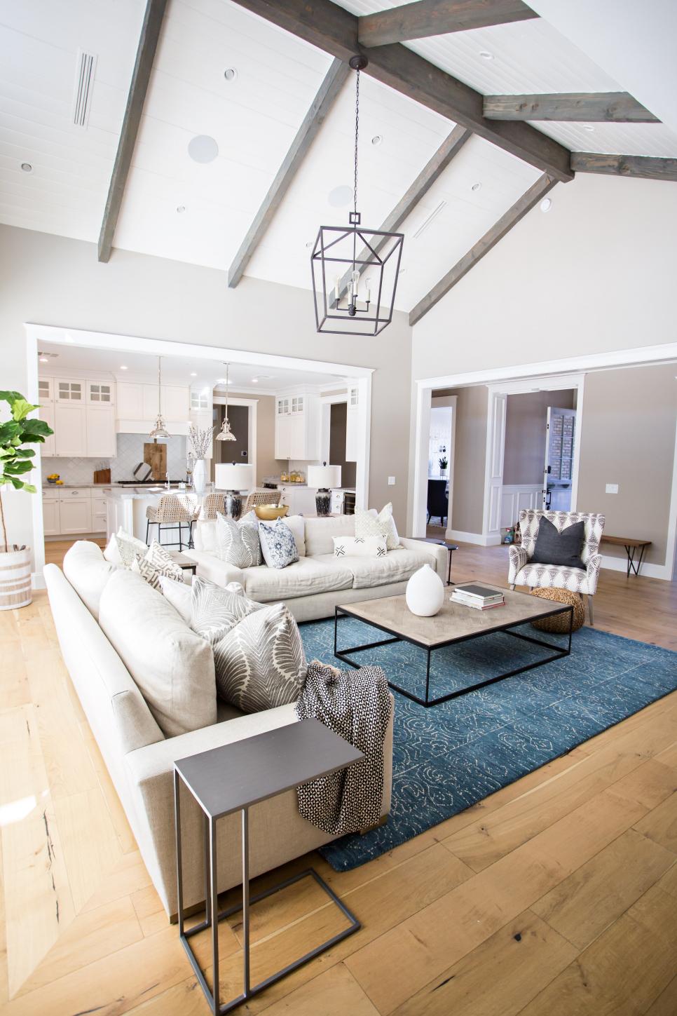 Modern Side Table Complements Caged Chandelier in Living Room transitional living room with metal side table