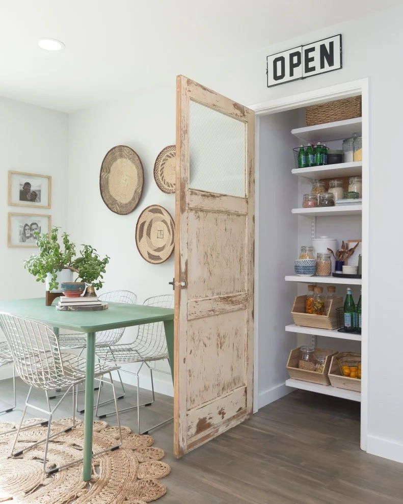 Pantry with Neutral Vintage Door and Green Dining TAble