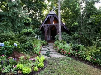 "I wanted something fairy tale-like" says Atlanta homeowner Rod Rusyniak of this charming—but functional— potting shed with tree bark siding and a weathervane salvaged from a Tennessee barn. 