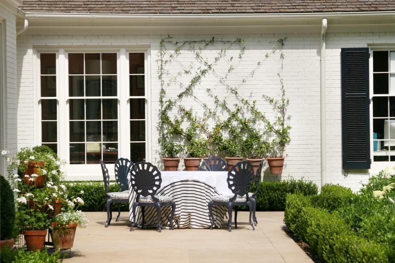 When appropriate and for parties, Rollins likes to use tablecloths on plain outdoor-ready tables  "because it feels more inviting." Using classic, simple terra-cotta pots throughout her garden allows her to keep a coordinated look and the pots can easily be used indoors as well.