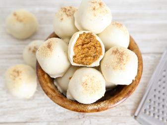 These truffles are three-ingredient wonders and a quick fix for busy holiday cooks. Combine 1 cup of graham cracker crumbs with 1/2 cup pumpkin pie filling and mash together until thick dough forms. Scoop mixture by 1 level tablespoon and place on a parchment-lined baking sheet. Roll each tablespoon of dough into a ball and freeze until solid (about 1 hour). Dip each ball into melted white candy coating (about 12 ounces) and place on parchment paper using two forks. Garnish each truffle with a pinch of grated nutmeg. Let stand until firm, about 30 minutes. Yields 13 truffles.