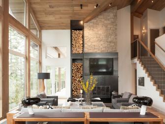 The renovation of this ski-house in Whistler, Canada started as a simple kitchen renovation but quickly blossomed into a whole-house update. Designer Robert Bailey made the most of the soaring interior volume, natural stone all the way to the wood-clad ceiling and turning wood storage into a design element. A neutral palette keeps the focus on the natural textures inside and the spectacular scenery outside the glass walls.