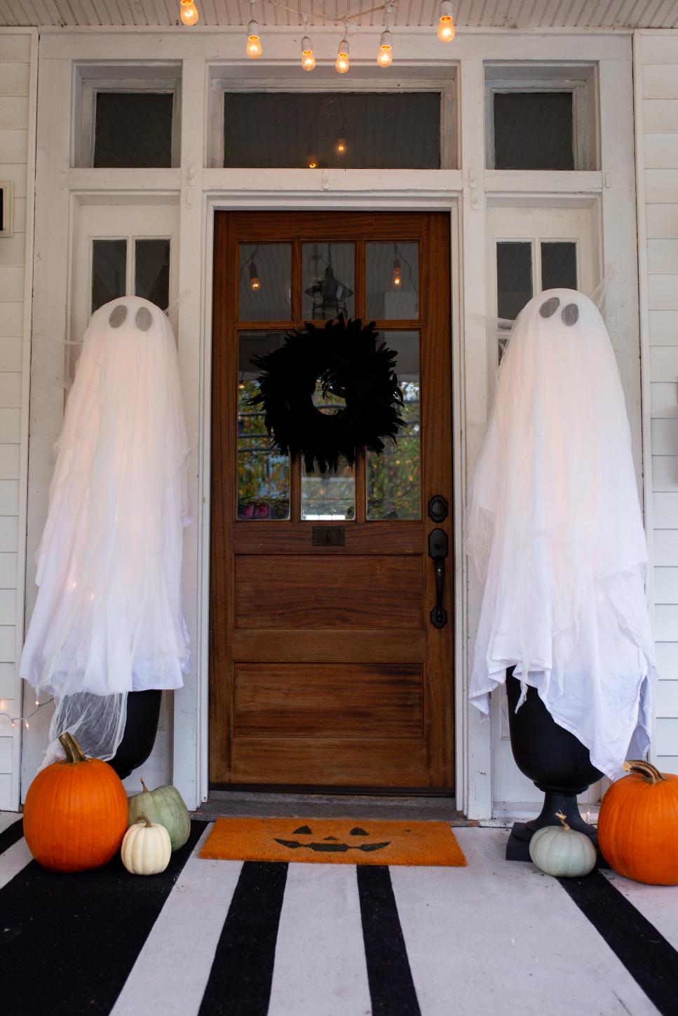 Ghost Halloween Decorations in Planters On a Porch Two Planters With White Ghosts Flanking a Doorway