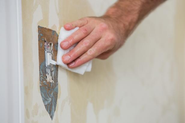 Use your scraper to remove the wallpaper around the outlet. If necessary, wet the area with a rag soaked in the hot water solution, wait a few minutes and scrape the wallpaper off.