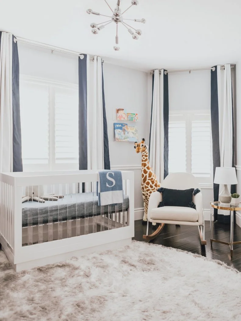 Modern Nursery With Acrylic Crib, Chrome Chandelier and Rocking Chair