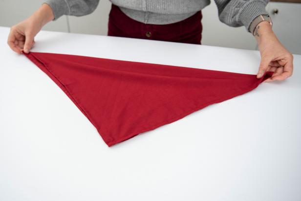 This folded napkin rose is sure to impress your guests this holiday season.