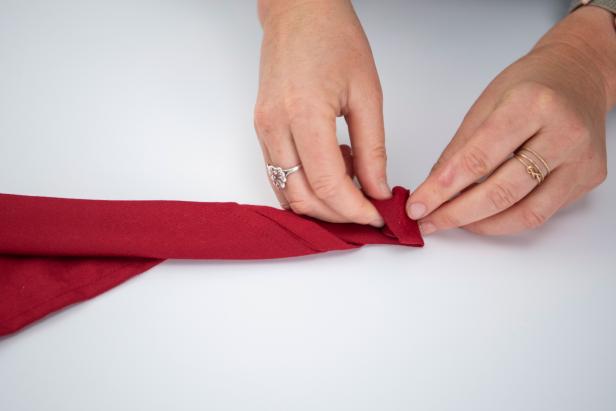 This folded napkin rose is sure to impress your guests this holiday season.