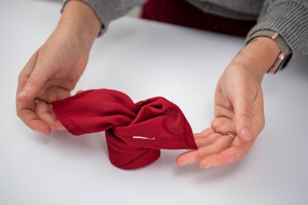This folded napkin rose is sure to impress your guests this holiday season.