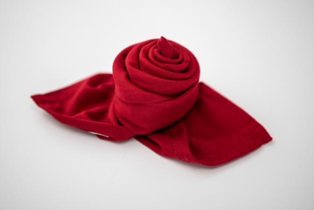 This folded napkin rose is sure to impress your guests this holiday season.