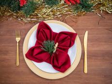 Red Napkin on Plate Folded With Four Points
