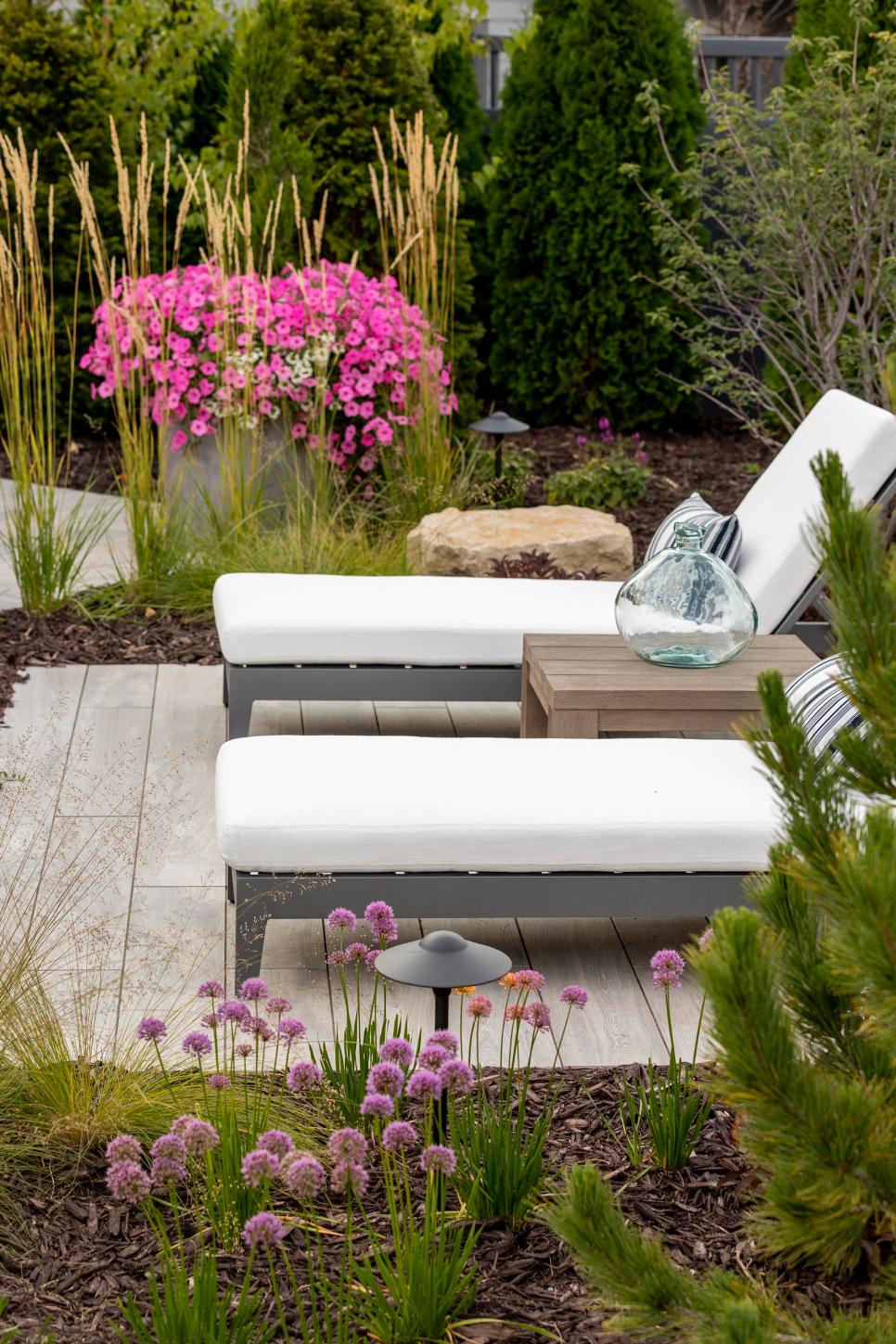 Contemporary Outdoor Seating Area Two Lounge Chairs With Rustic Table Between On Contemporary Patio