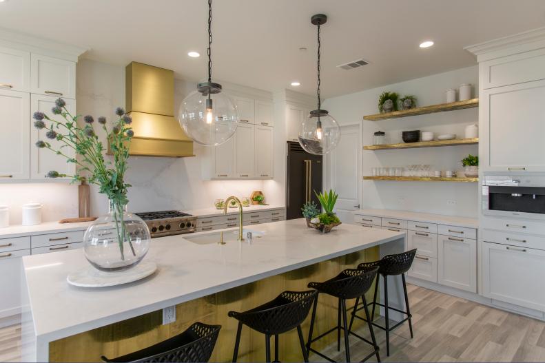 White Quartz Island and Brass Finishingin White Kitchen 