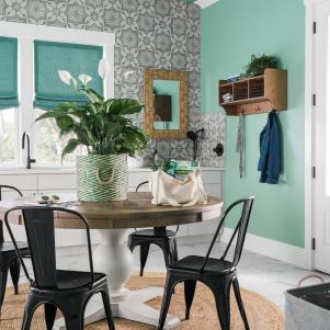 Wood Pedestal Table on Round Neutral Woven Rug in Green Laundry Room
