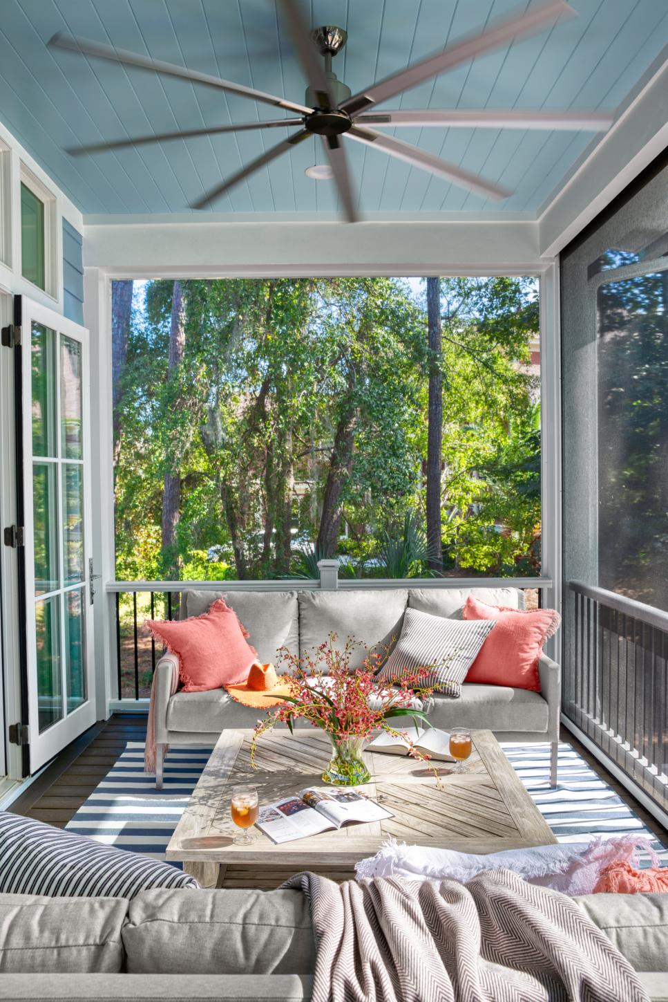 Outdoor Retreat Screened-In Porch Houses Welcoming Living Room With Ceiling Fan