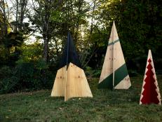 Three Plywood Christmas Trees in Varying Heights Displayed in Yard 