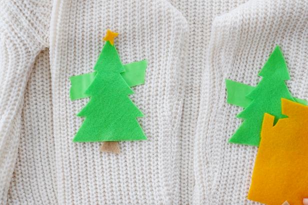 Embellish a plain white sweater with festive Christmas tree elbow pads for the holidays.