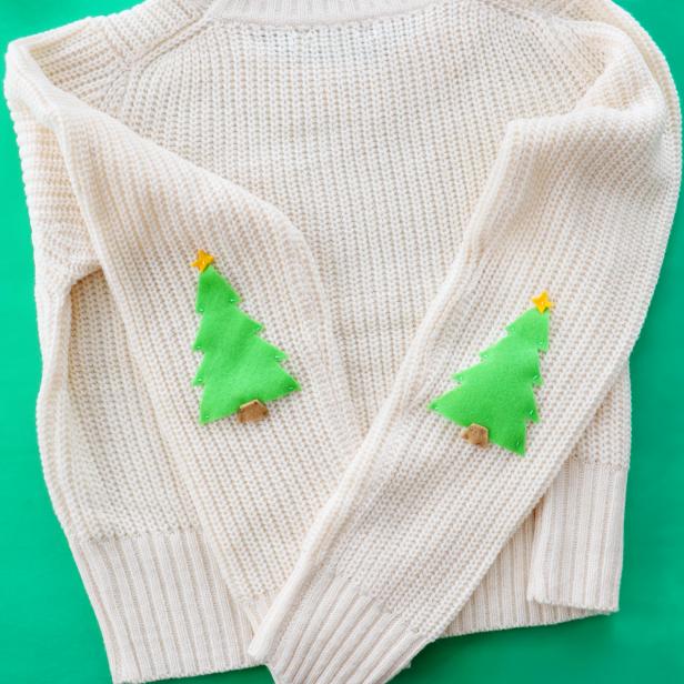 Embellish a plain white sweater with festive Christmas tree elbow pads for the holidays.