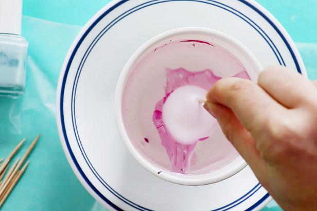 Next, dip the ping pong ball into the nail polish to create an instant marbled effect.