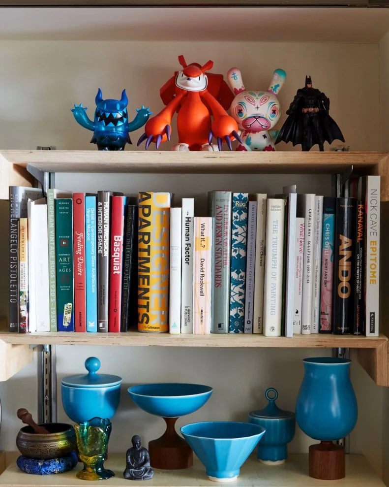 Everything in this home is art. Even in this small cross-section of the bookshelf everything from the books to the figurines and the ceramics on the bottom shelf come together to create a moment and express a perspective. “I love the fact that everything we have collected has been selected with care and thoughtfulness,” says Leyden. For him, it’s these small details and the reflection of personalities more than anything else that makes the space feel like a home.