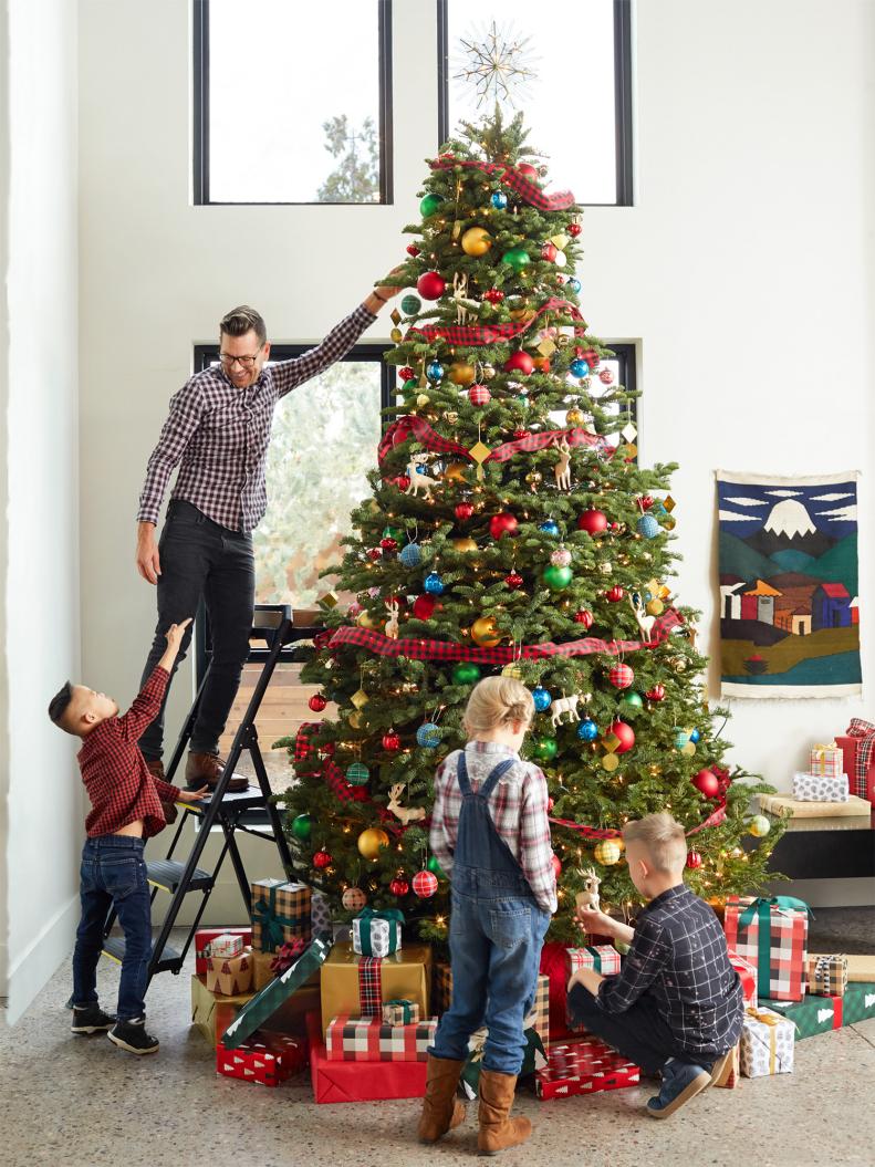 That’s one tall tree — 15 feet! Luke hangs finishing touches with direction from Tucker, while Brighten and Elias fill in the bottom.