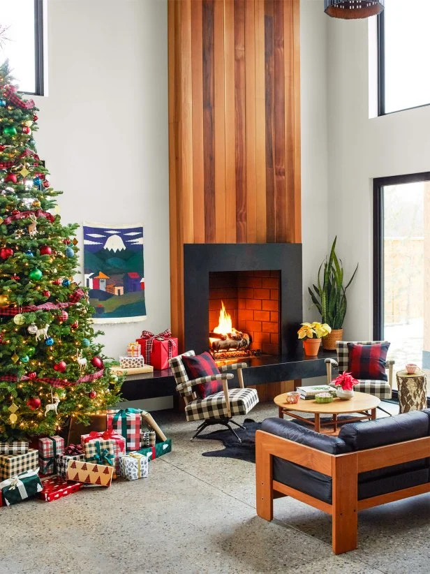 Going for maximum airiness, Luke and Clint gave this space a 20-foot-high ceiling and two-story windows. It’s cozied up by a gas fireplace clad in smooth cedarwood, with soapstone on the hearth. Aggregate concrete floors with embedded river rocks stand up to occasional basketball dribbling. The 1960s leather sofa and the rockers are from Boise Vintage—Luke had the chairs reupholstered in buffalo check fabric from JoAnn. 