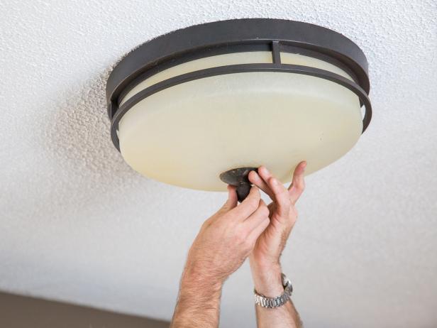 Determine how your light is attached to the electrical box. Most will be secured with decorative nuts and mounting brackets. Use pliers to unscrew and detach your light fixture from the ceiling.