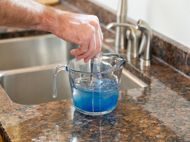 Mix four parts warm water with one part laundry detergent. Use a rough sponge or a soft bristle brush to apply the cleaning mixture to your upholstery.
