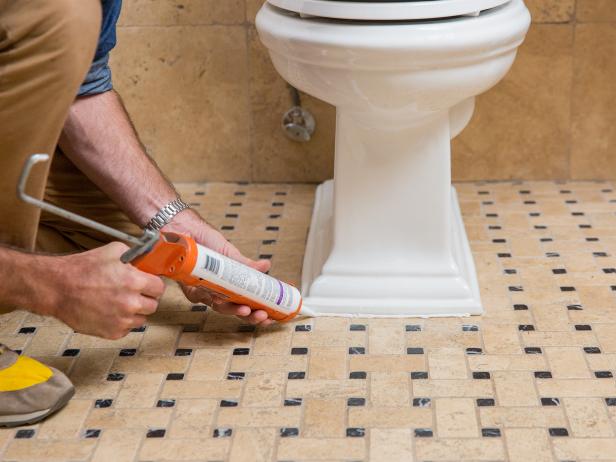 The final step is to seal around the base of the toilet with silicone caulk. It’s wise to use your toilet for a day or two before applying the silicone. You want to be extra sure there are no leaks from the base. Once you’re certain everything is installed correctly, run a bead of silicone caulk around the base of the toilet. You can use your finger as a trowel to create a smooth seam.