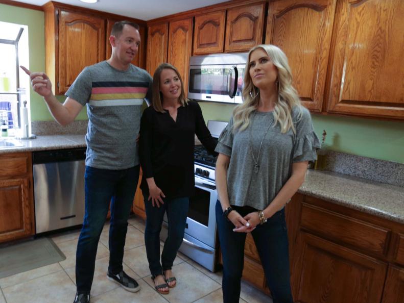 Host Christina Anstead (right) listens as clients Jamie and Travis (left) explain the woes of their  Fountain Valley, CA kitchen, as seen on HGTV's Christina on the Coast.