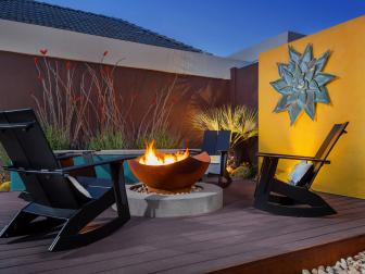 Raised Patio with Rustic Circular Fire Pit and Yellow Wall 