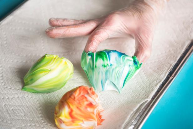 Use household essentials like shaving cream and food coloring to create beautiful marbleized Easter eggs.