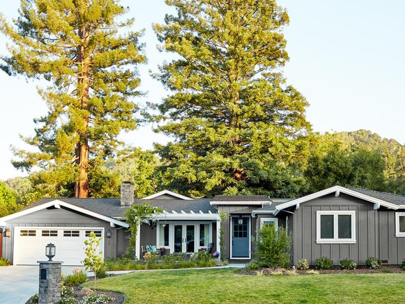 This one story house from HGTV Magazine has a graphite gray exterior and a blue door.