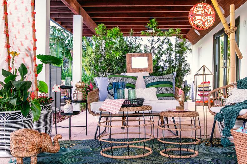 The bright colors and natural materials used to decorate this covered patio give it a relaxing tropical feel. 