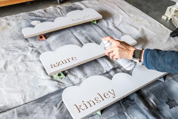 DIY Cloud Bookshelf: Paint and Personalize the Clouds Spray Painting Cloud-Shaped Bookshelf Fronts