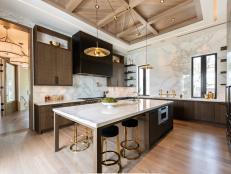 Kitchen with Marble Walls and Countertops and Large Island