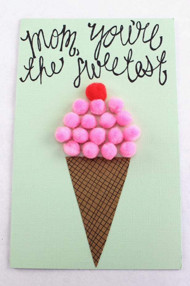 Make an ice cream cone card for Mother's Day this year using minimal materials including pom-poms, kraft paper and marker.