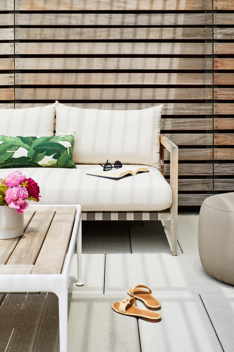 Inviting Outdoor Patio With Natural Elements Close Up View Of Outdoor Furniture And Wooden Deck Wall
