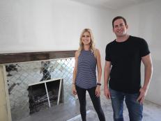 Hosts Christina and Tarek El Moussa stand in front of the finished fireplace of this Fullerton, CA home, as seen on HGTV's Flip or Flop.