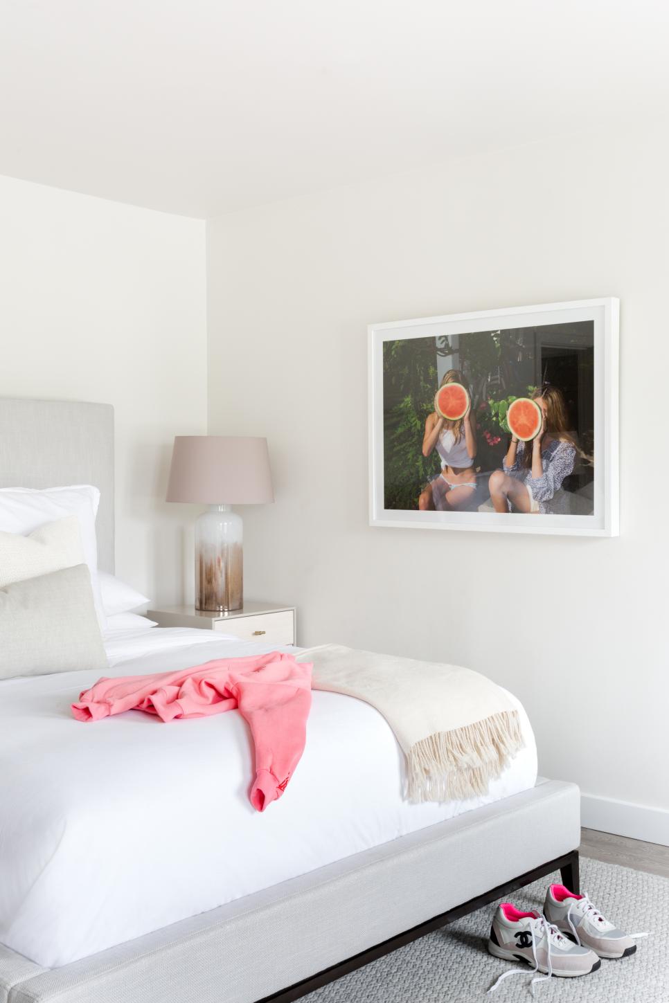 Guest Bedroom In Shades Of White Modern Art Hangs In Guest Bedroom Near Large Table Lamp