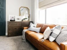 Close Up Of Leather Sofa In Bedroom With Lots Of Throw Pillows