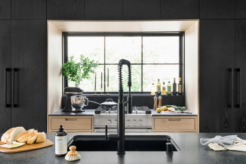 Black Gooseneck Faucet on Kitchen Island in Front of Large Window
