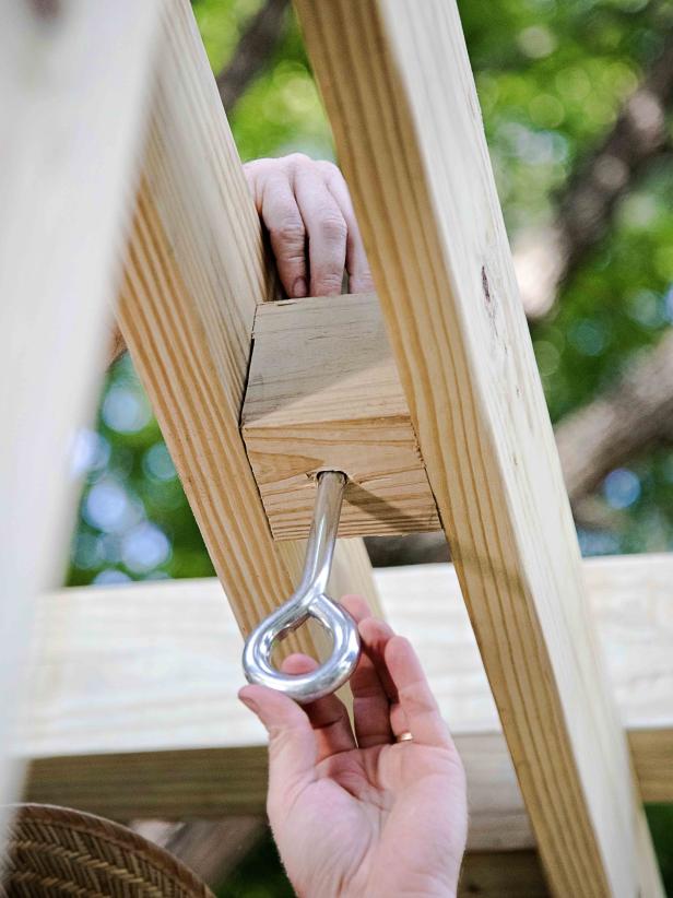 Attach eye bolts to the structure that you will hang the swing from — a pergola in our case.