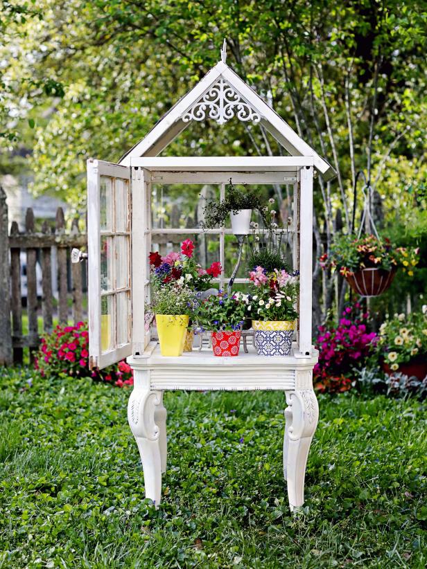 Did you impulsively buy a load of old windows at the thrift store, but now have no idea what to do with them? Even if your answer is "no," this DIY is definitely one to put on your to-do board. Not only is it easy to build from upcycled items, but is an absolutely stunning backyard centerpiece when filled to the brim with all of your favorite plants.