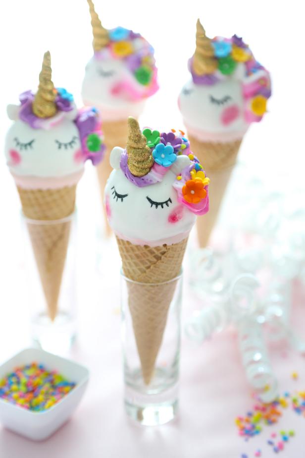 These colorful cake pop cones will bring lots of magic and cuteness to your next party. They’re not hard to make, but you’ll need two specialty cake decorating items to make the sparkling unicorn horns. You can find edible gold paint and nontoxic edible glitter for purchase online and in the baking aisle at your local craft store. 