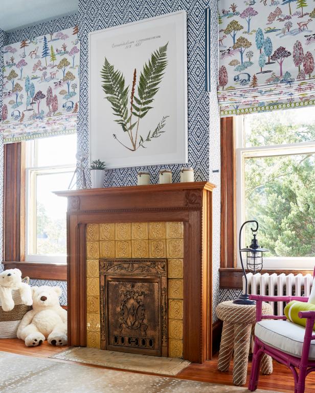 Patterned Roman Shades Flank Warm Wood-Trimmed Fireplace