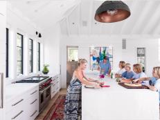 With four boys from 12 to 17 (and dog Lucy), downsizing from a 4700 square foot home to a 2600 square foot one, meant that Elizabeth and Curt Nesbitt had to be smart about their space. Their stunning, contemporary Sullivan's Island home on the lush green marsh of the Intracoastal Waterway benefits from an airy, open living room, dining room and kitchen on the home's second floor. Floor to ceiling windows let the light flood in and make the space appear even more expansive. Designer Jenny Keenan worked with the Nesbitts on the smart, chic design of their spacious-feeling home.