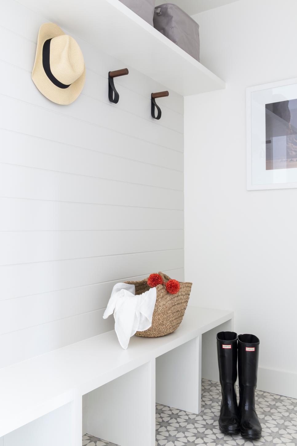 Modern White Tile Foyer Modern Foyer With White Tiles, Hat On A Hook, And Boots On Tile Floors
