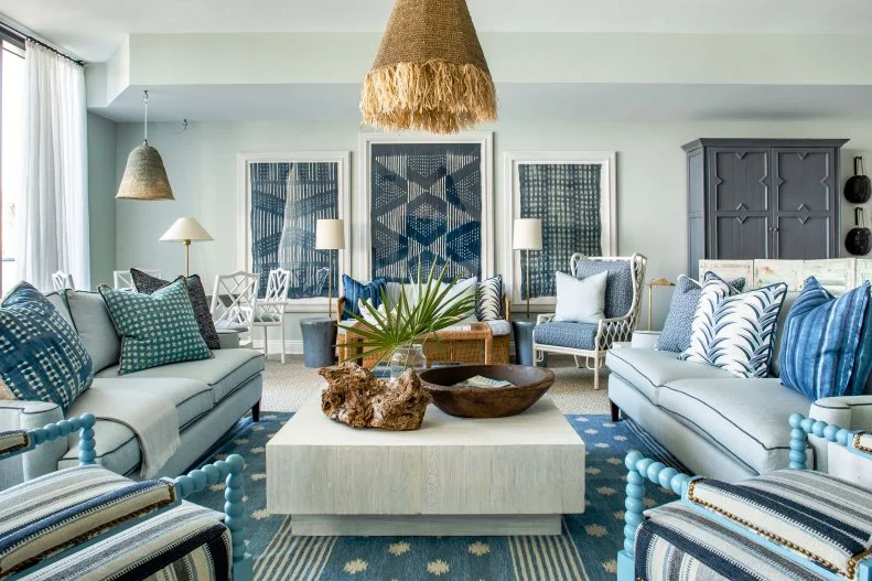 Living And Dining Space With Patterned Art, Rug And Pillows On Sofa