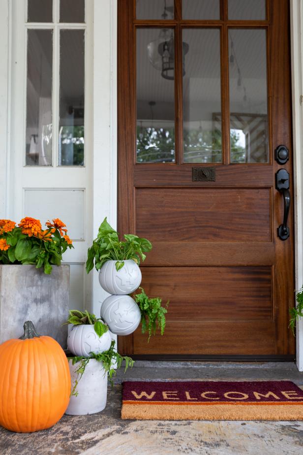 A Plastic Pumpkin Planter Beside a Wooden Door